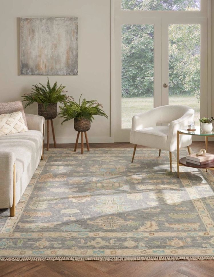 patterned area rug in a Sand City living room with french doors, couch, and chair