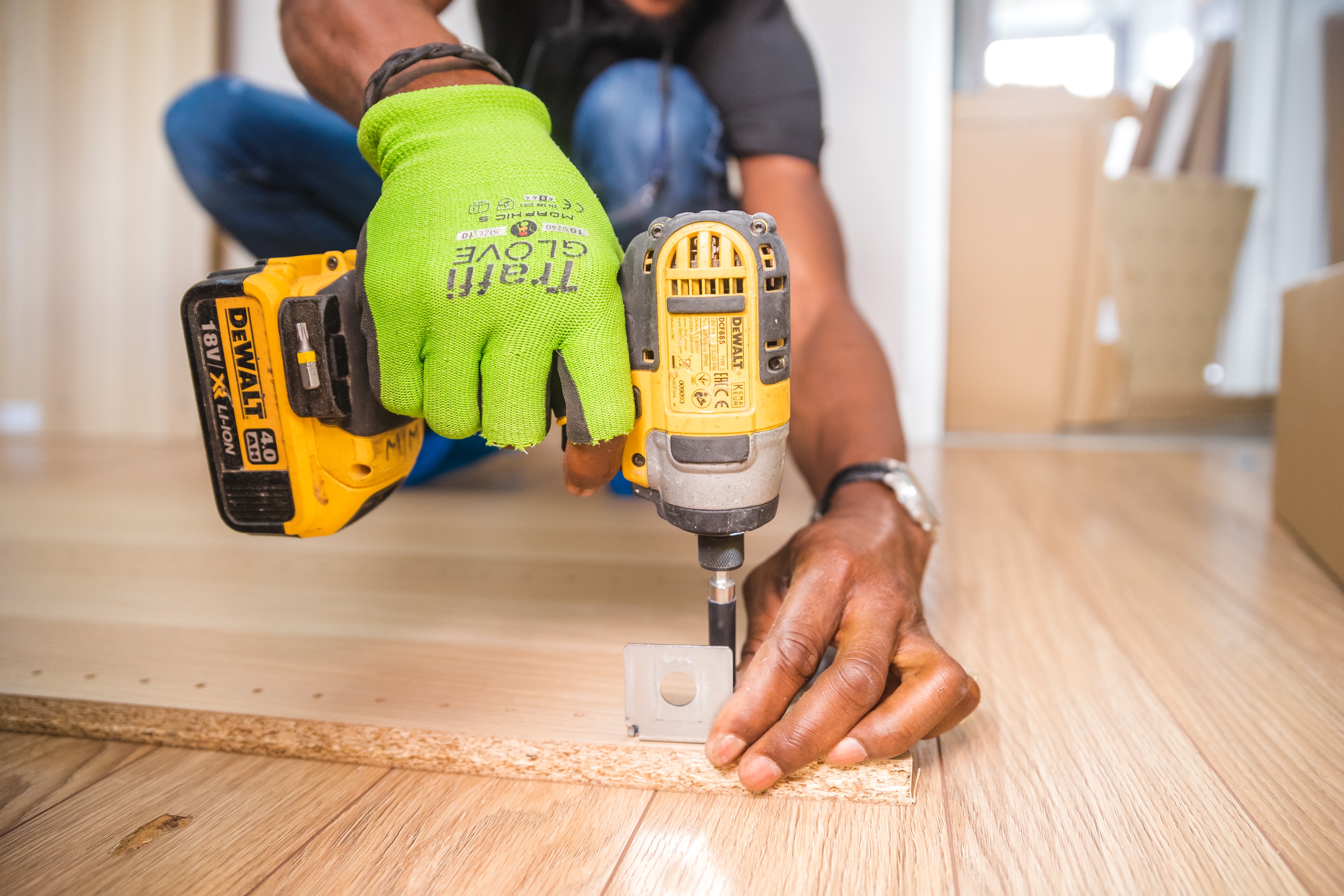 Stock Photo featuring flooring installer close up with drill.