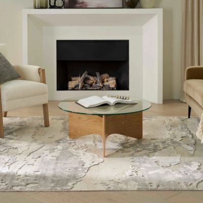 patterned area rug in a living room with coffee table and fireplace