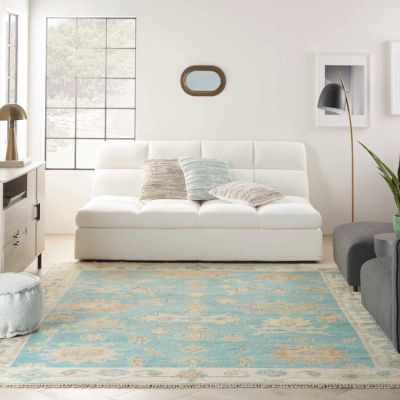blue patterned area rugs in a bright Sand City living room with white couch