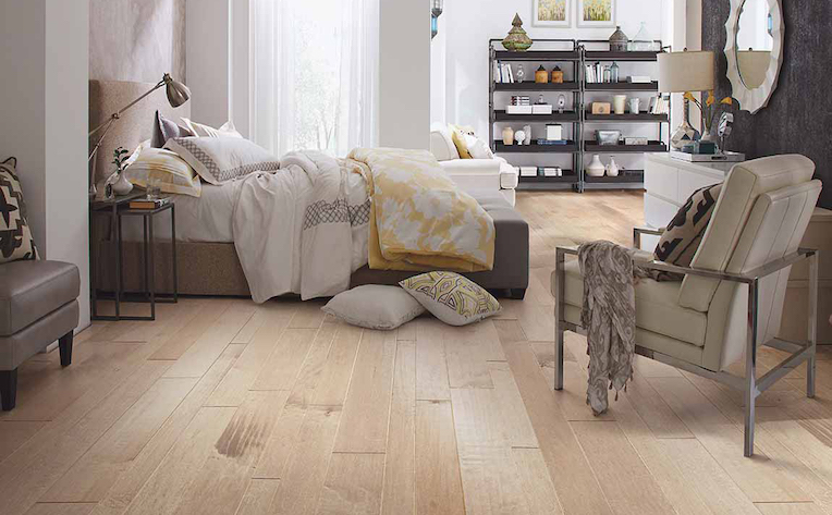 wide plank hardwood flooring in a bright and beachy bedroom